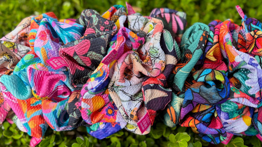 Colorful scrunchies on green leaves