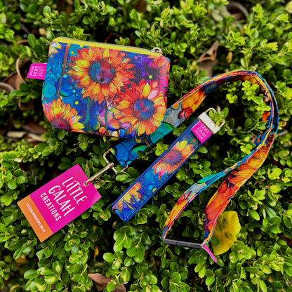 Colorful Sunburst Blooms pouch and strap on a green leafy background