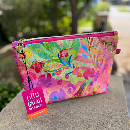 Colorful pouch with floral design on a stone surface, featuring 'Little Galah Creations' label.